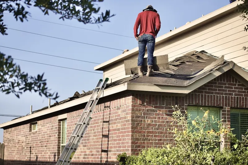 Professional roofer working on a residential roof in Grand Palms